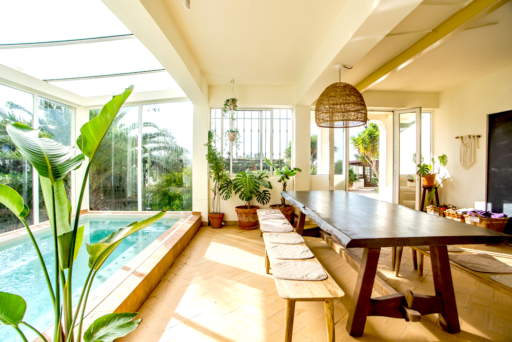 Sunlit communal dining room beside the indoor pool at AltaVista Lodge