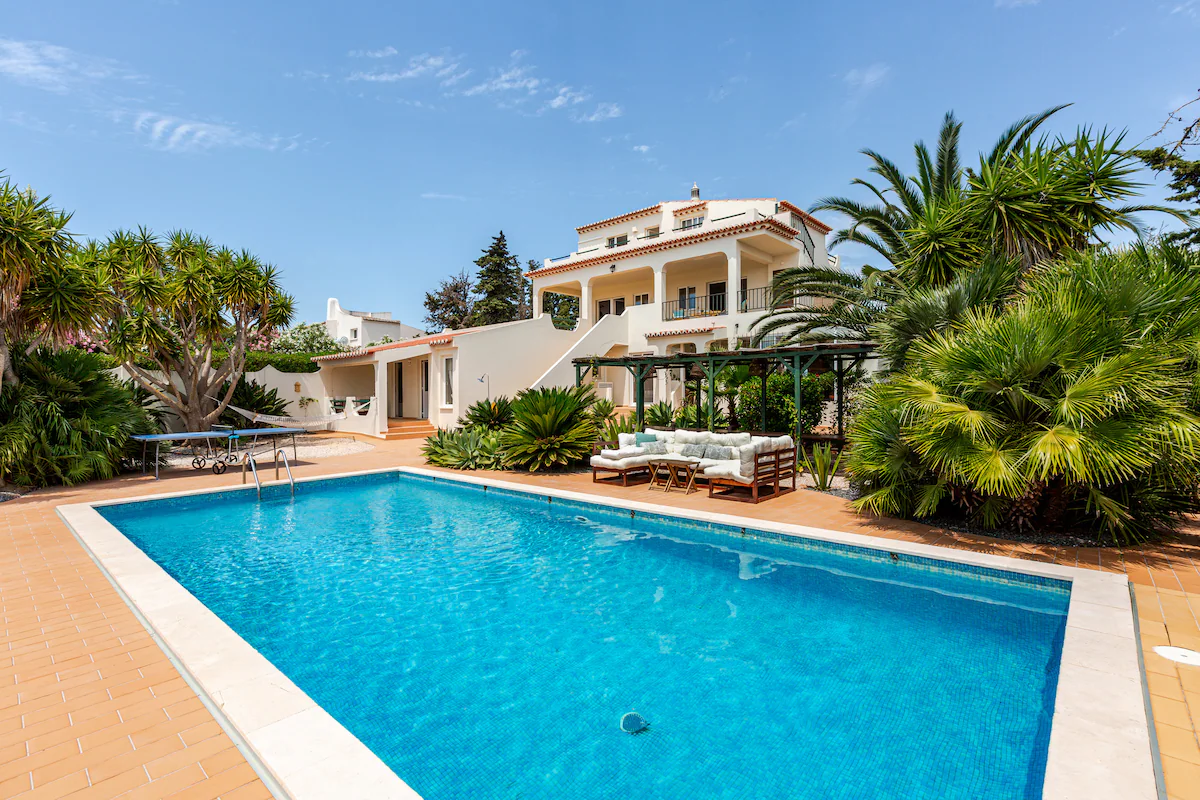 Outdoor pool and palm-lined villa at AltaVista Lodge, Portugal